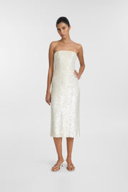 A model wearing an ivory strapless midi dress with a corseted bodice and hand-beaded sequin detailing, photographed against a seamless light grey studio background.